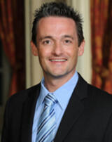 [Photo of Leonard Gilroy]